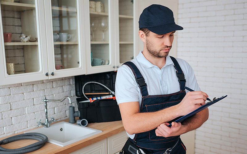 busy-young-handyman-stands-kitchen